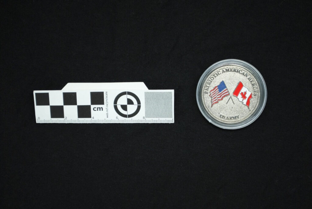 Back side of the coin, featuring both countries' flags